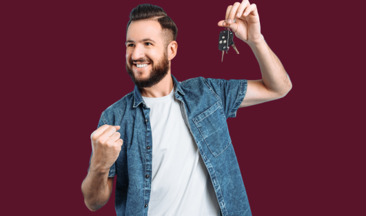 A man making a fist, smiling, and holding a set of keys.