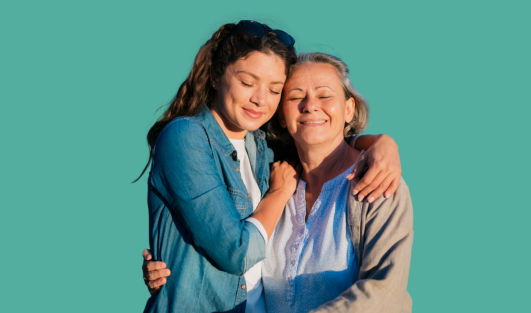 A younger woman hugging an older woman.