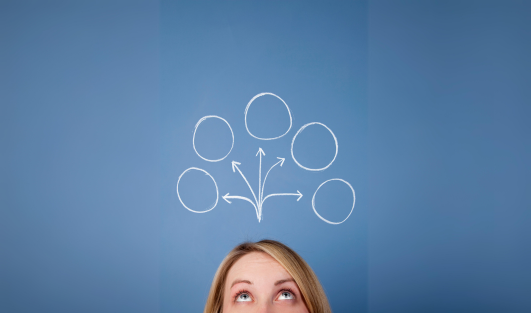 A woman looking up with blank thought bubbles above her.