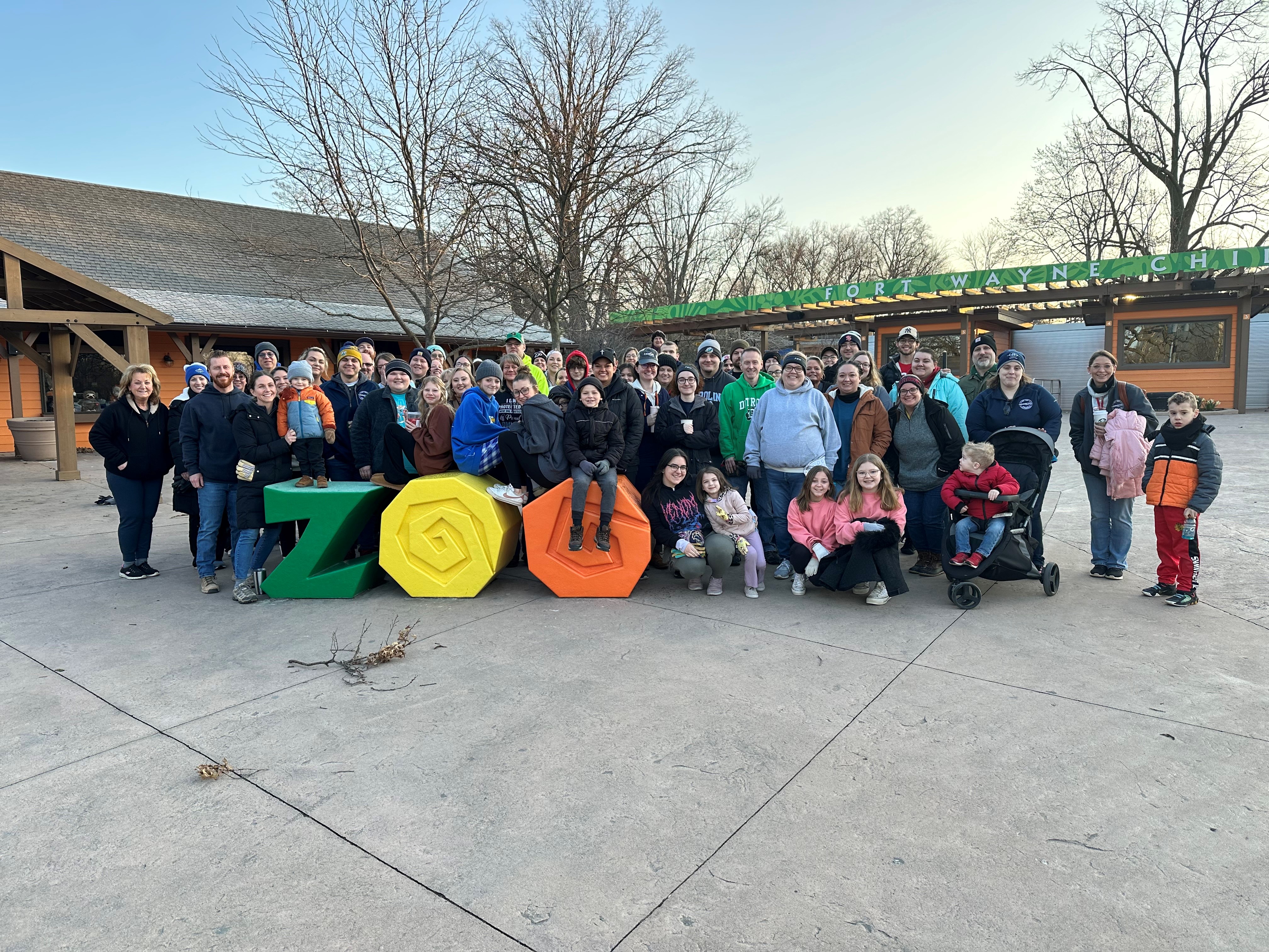 ProFed Credit Union employees gathered around the entrance of Fort Wayne Children's zoo before volunteering time.