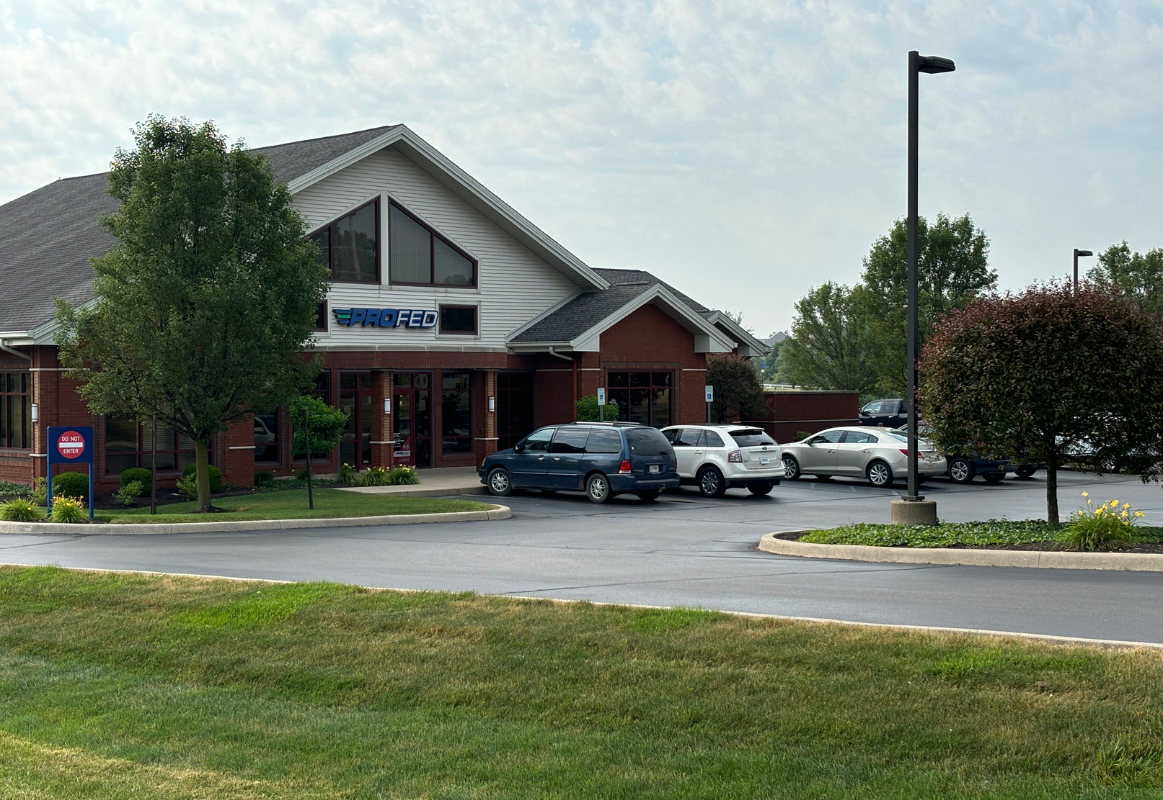 An image of the Angola Branch with three cars in the front parking lot.