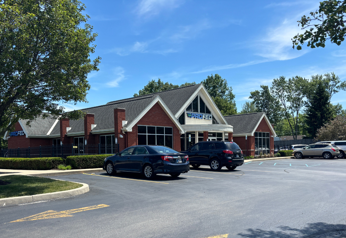 An image of the Stellhorn ProFed Credit Union branch with two cars in the foreground.