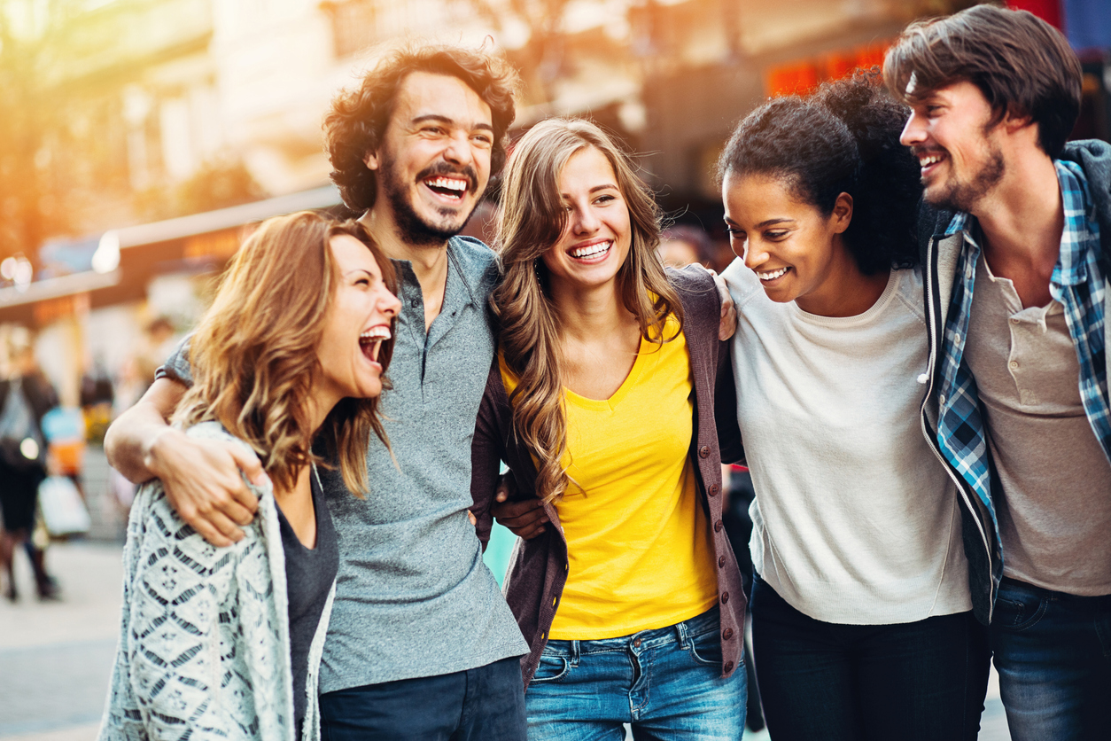 A group of happy friends on the street in town. 