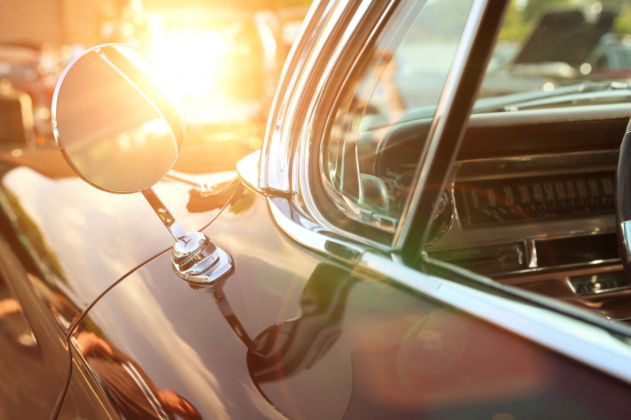 Sun shining in on a car side mirror.
