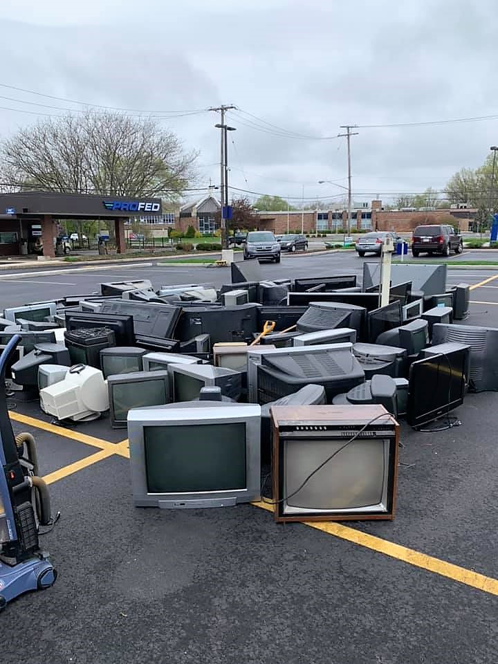 Used electronics piled up in the parking lot to be picked up to recycle.