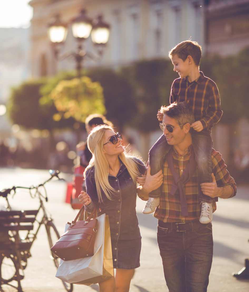 A happy family shopping on a sunny day.