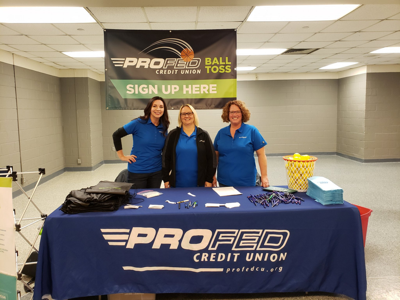 ProFed employees hosting a booth at the Mad Ants game for Ants Awareness in Action sponsorship.