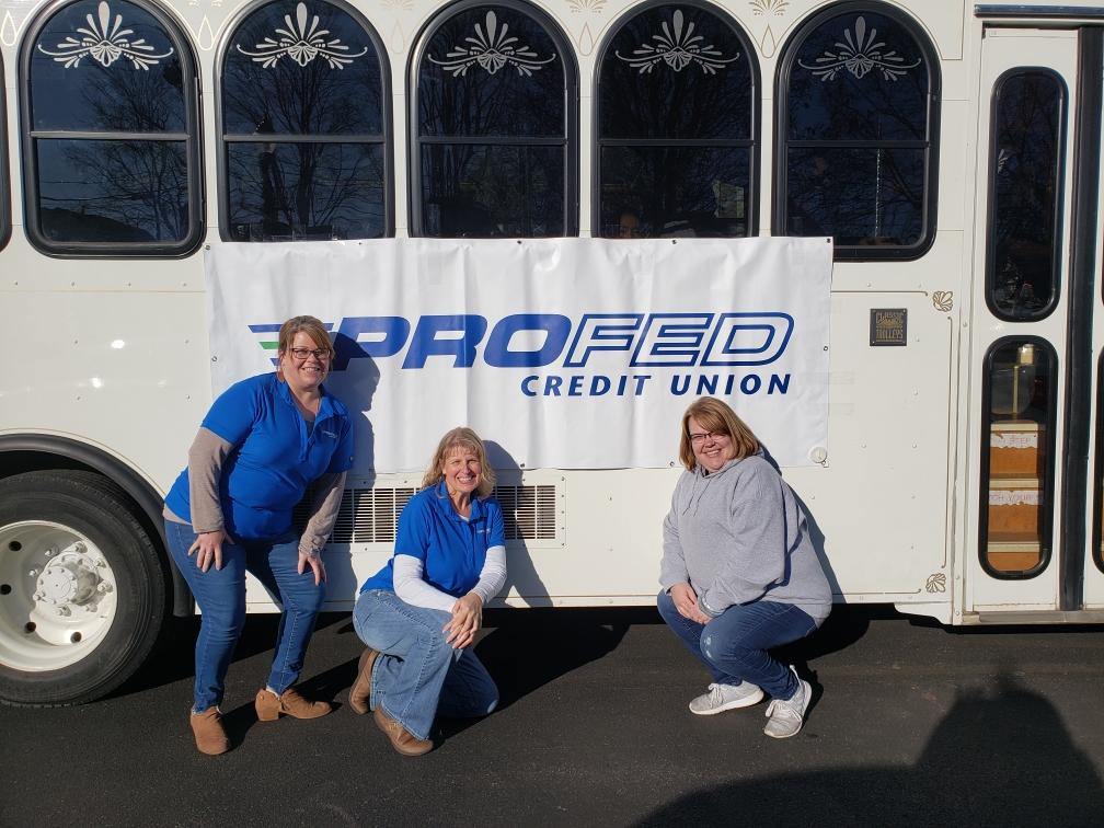 ProFed volunteers in front of the trolley in Bluffton for the Parlor City Christmas event.