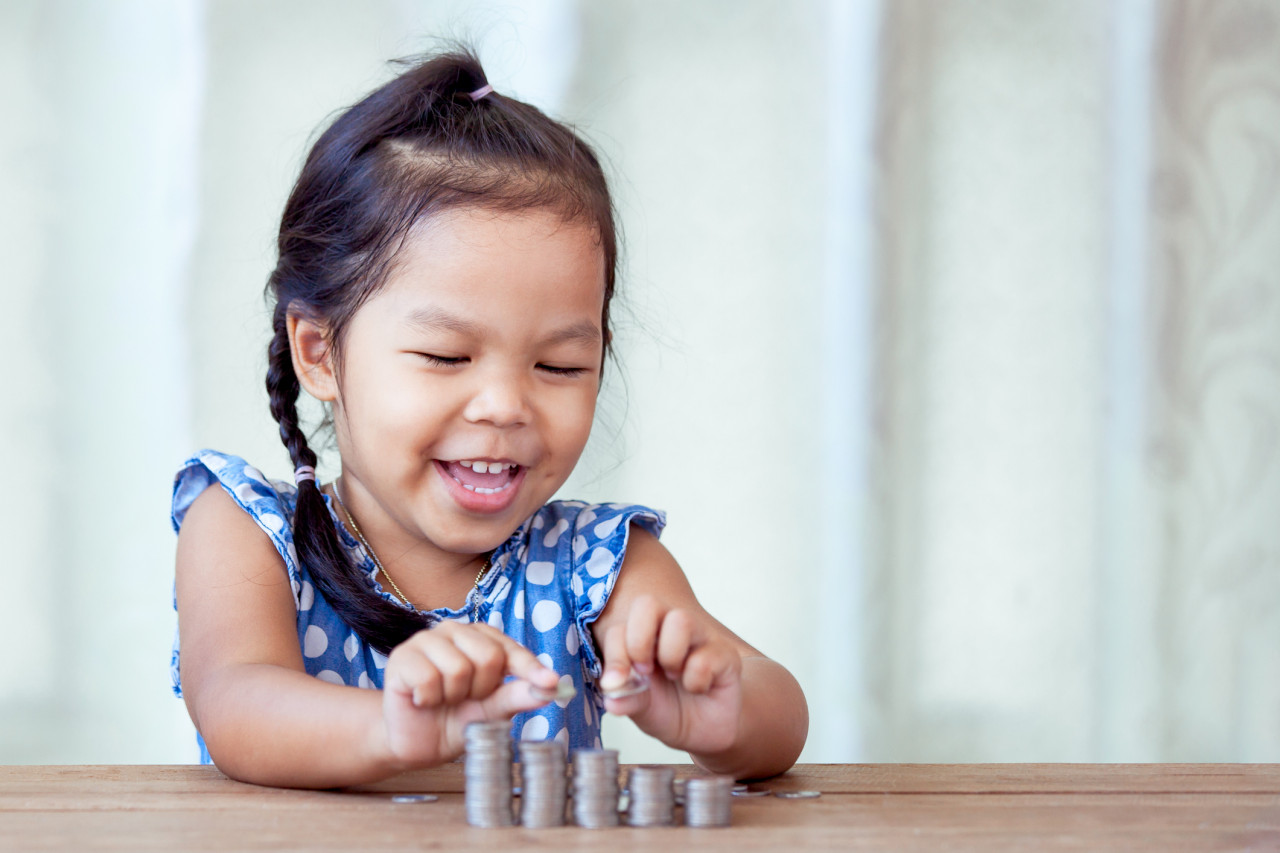 A young girl counting money.