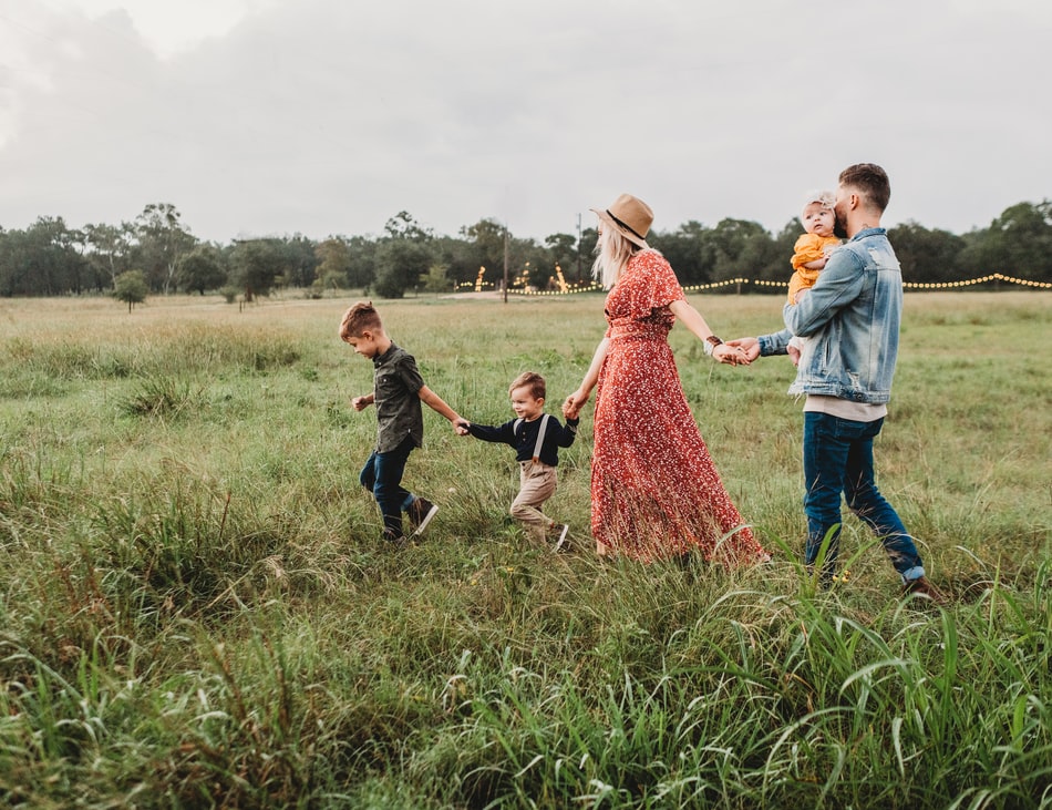 A family walking through tall grass.